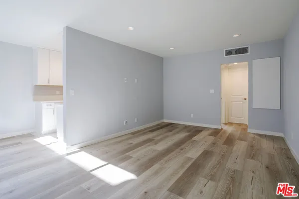 a view of an empty room and wooden floor