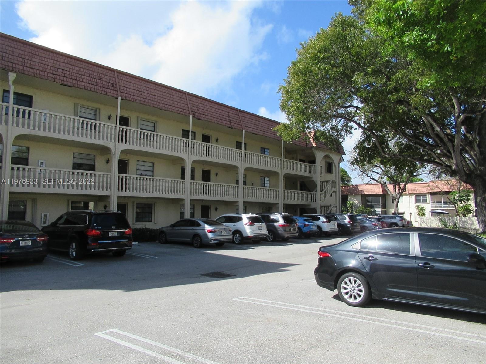 130 South Cypress Road, Unit 612 Pompano Beach, FL 33060 - Photo 32 of 33 a car parked in front of a building