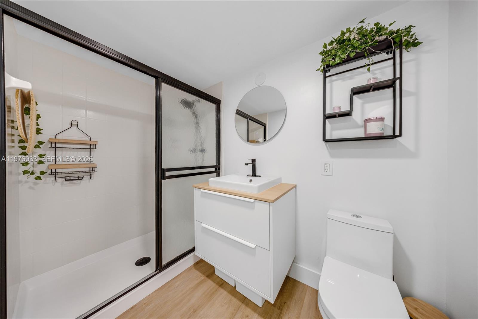 130 South Cypress Road, Unit 612 Pompano Beach, FL 33060 - Photo 5 of 33 a bathroom with a toilet sink and shower
