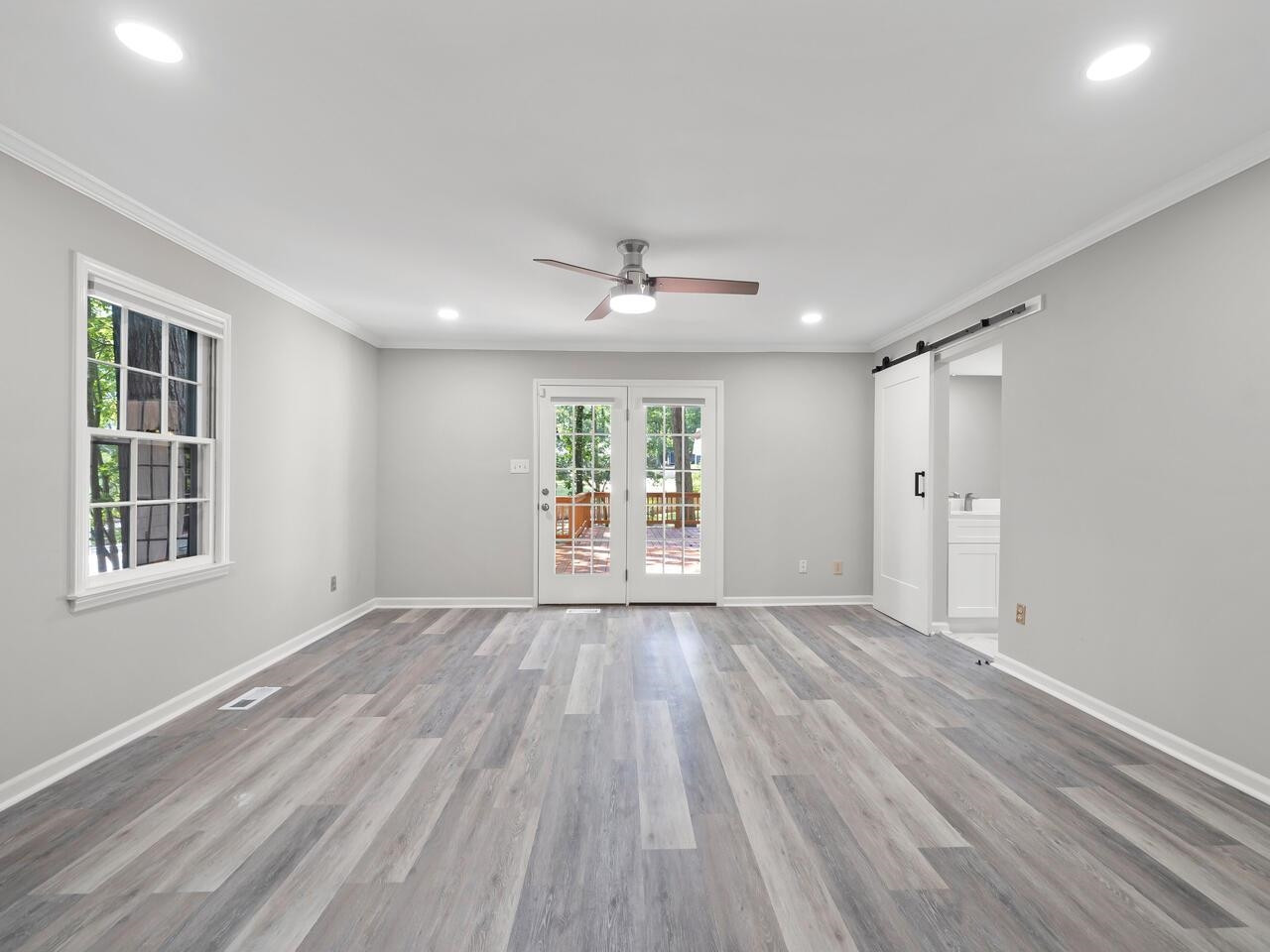 4504 Wenchelsea Place Raleigh, NC 27612 - Photo 18 of 27 a view of an empty room with a window and wooden floor