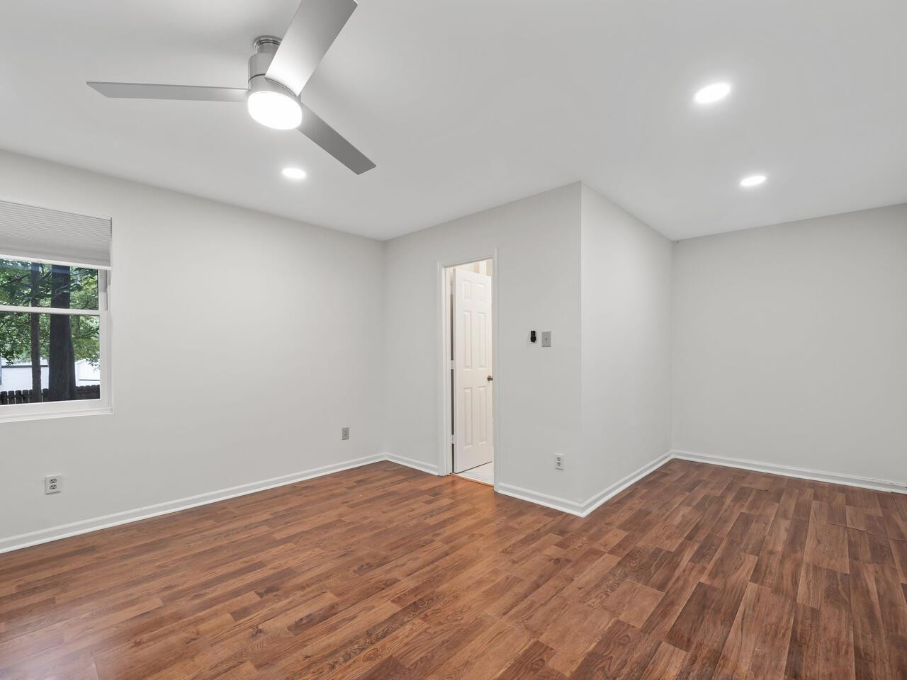 4504 Wenchelsea Place Raleigh, NC 27612 - Photo 23 of 27 an empty room with wooden floor and windows