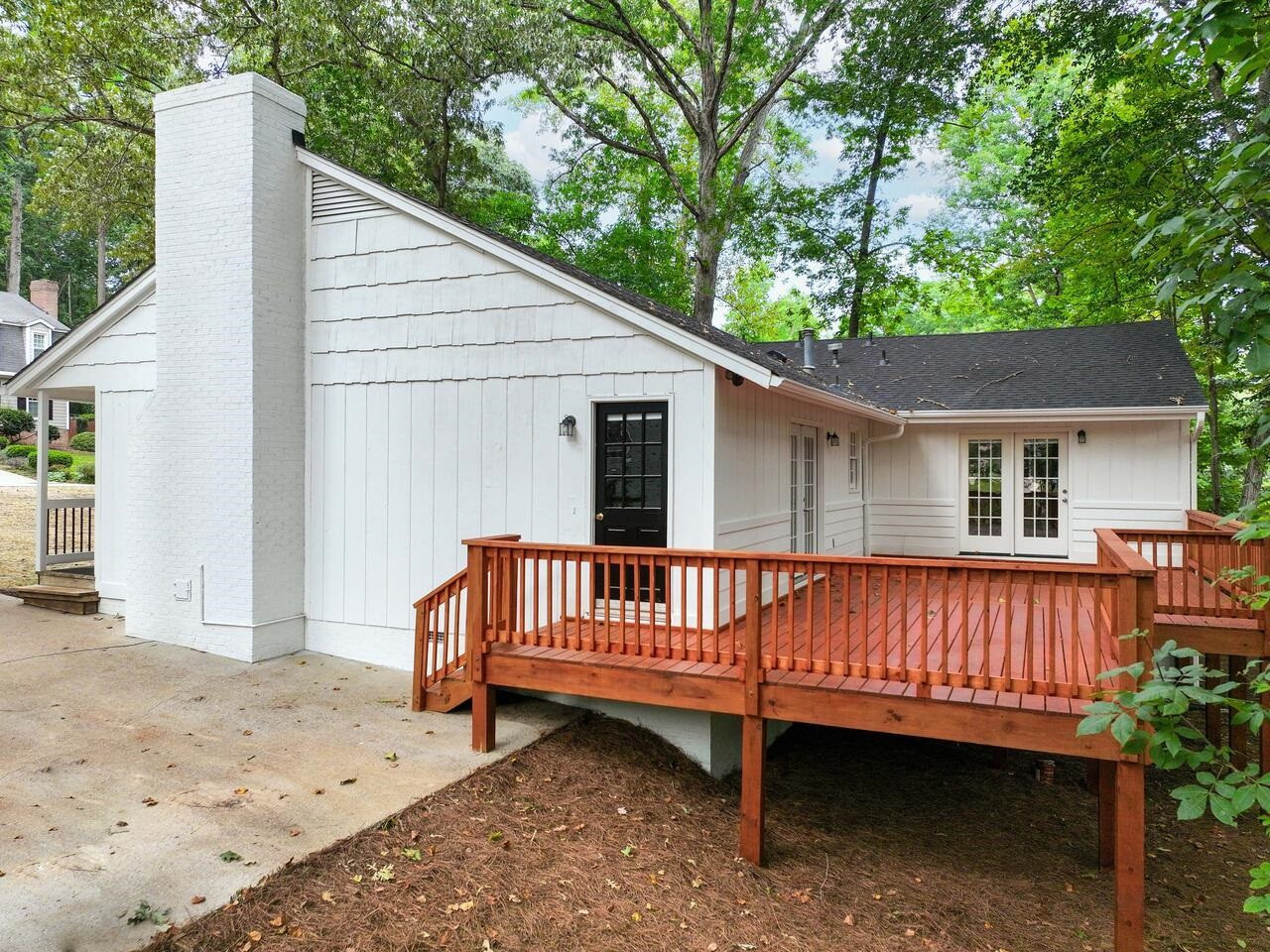 4504 Wenchelsea Place Raleigh, NC 27612 - Photo 24 of 27 a view of a wooden deck with a bench and a large tree