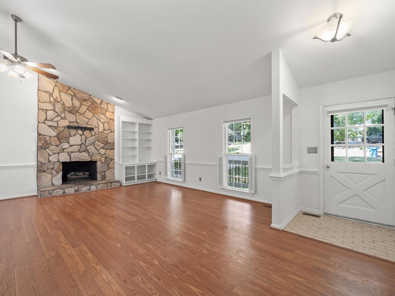 4504 Wenchelsea Place Raleigh, NC 27612 - Photo 7 of 27 a view of an empty room with wooden floor and a window
