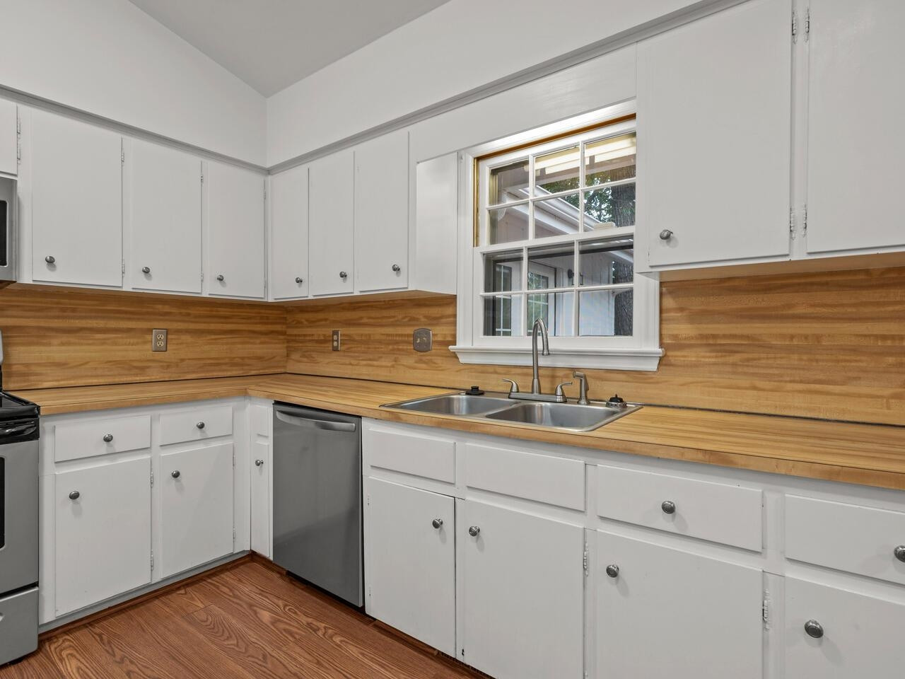4504 Wenchelsea Place Raleigh, NC 27612 - Photo 10 of 27 a kitchen with stainless steel appliances granite countertop white cabinets and a sink