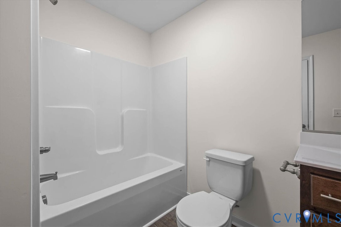 11325 Webb Road Disputanta, VA 23842 - Photo 21 of 32 a white toilet sitting next to a bath tub