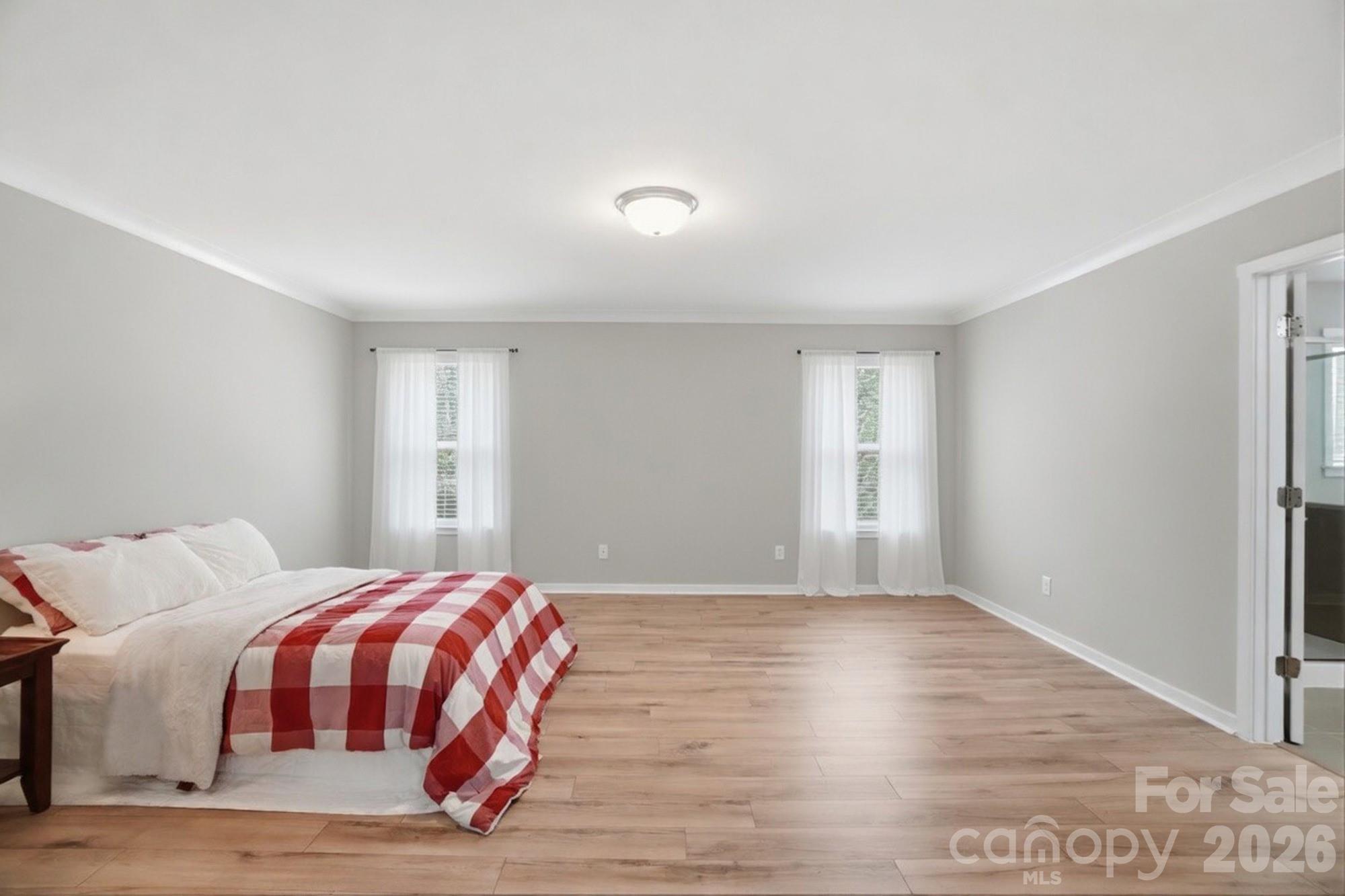 2153 Bluebell Way Tega Cay, SC 29708 - Photo 27 of 48 a bedroom with a bed and a window