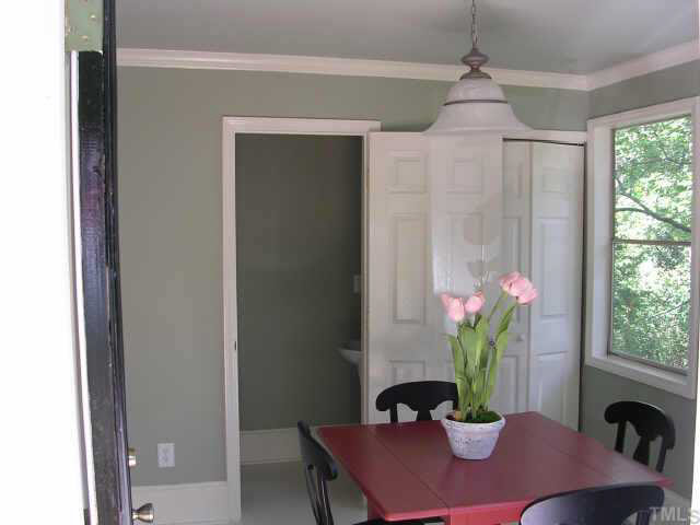 1837 White Oak Road Raleigh, NC 27608 - Photo 5 of 10 a dining room with furniture and a potted plant