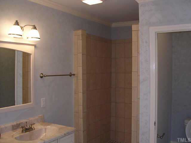 1837 White Oak Road Raleigh, NC 27608 - Photo 7 of 10 a bathroom with a sink and a mirror