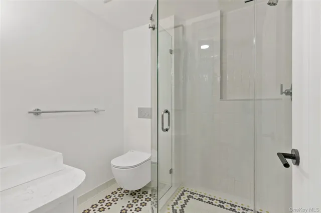 a bathroom with a toilet and a shower