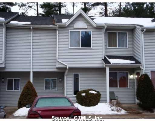 155 Redstone Hill Road, Unit 79 Bristol, CT 06010 - Photo 1 of 1 a front view of a house with a yard and garage