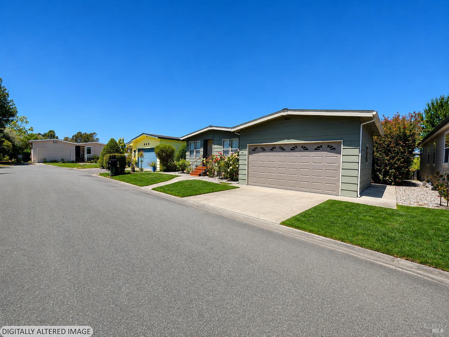 1945 Piner Road, Unit 16 Santa Rosa, CA 95403 - Photo 3 of 18 a front view of a house with a yard and garage