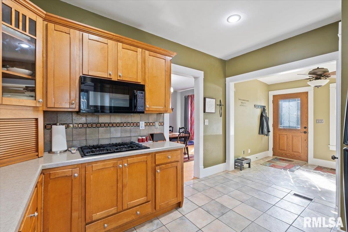 101 South Stewart Street Geneseo, IL 61254 - Photo 15 of 41 a kitchen with stainless steel appliances granite countertop a stove a sink and a microwave