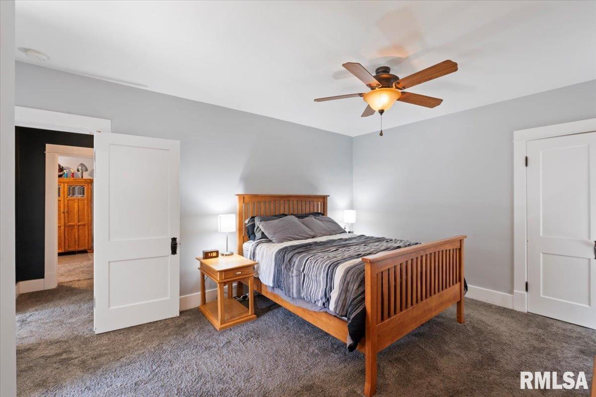 101 South Stewart Street Geneseo, IL 61254 - Photo 34 of 41 a bedroom with a bed and a chandelier fan