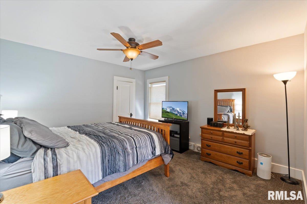 101 South Stewart Street Geneseo, IL 61254 - Photo 35 of 41 a bedroom with a bed and a chandelier