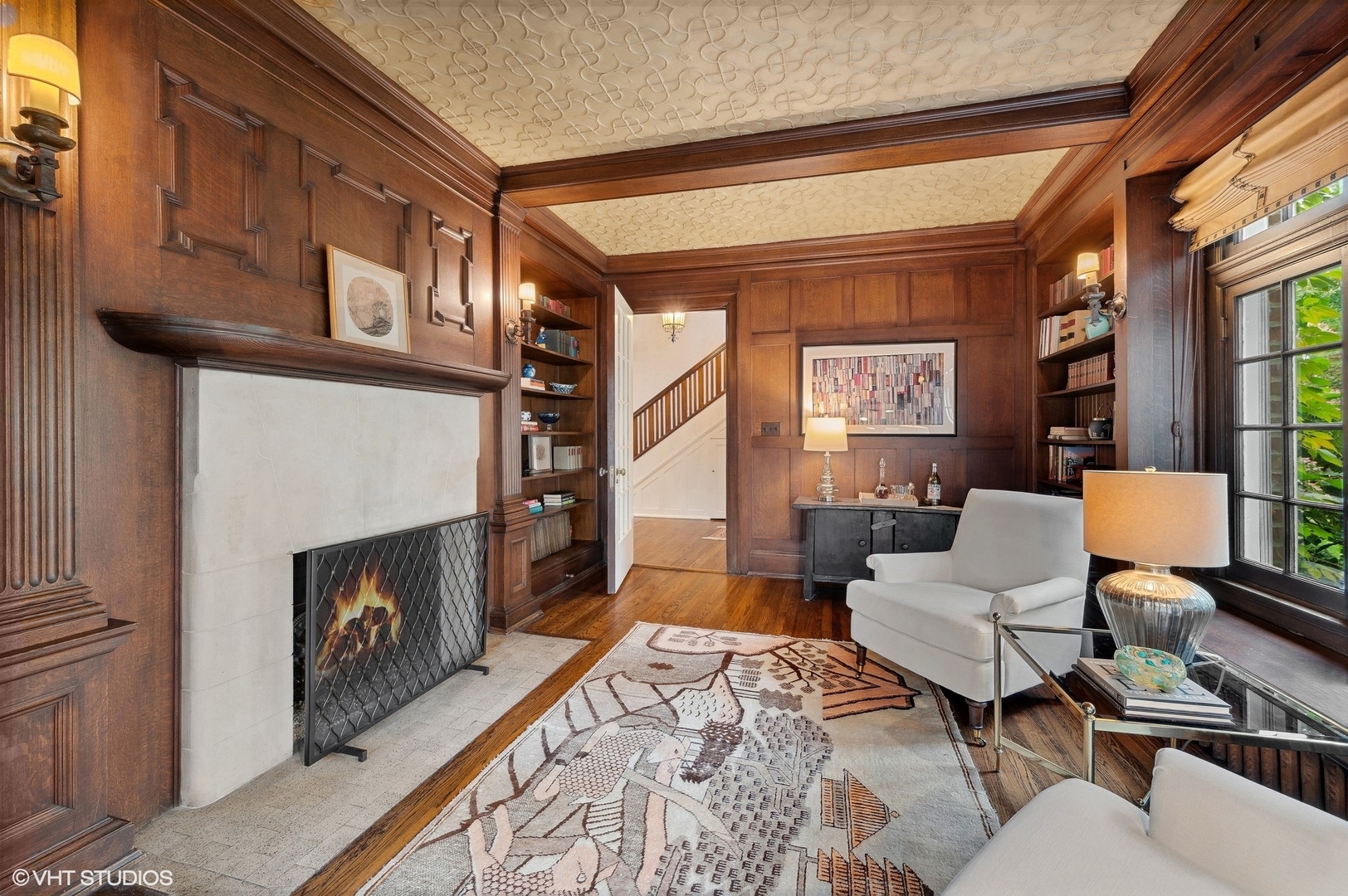 888 Tower Road Winnetka, IL 60093 - Photo 22 of 80 a living room with furniture a fireplace and a floor to ceiling window