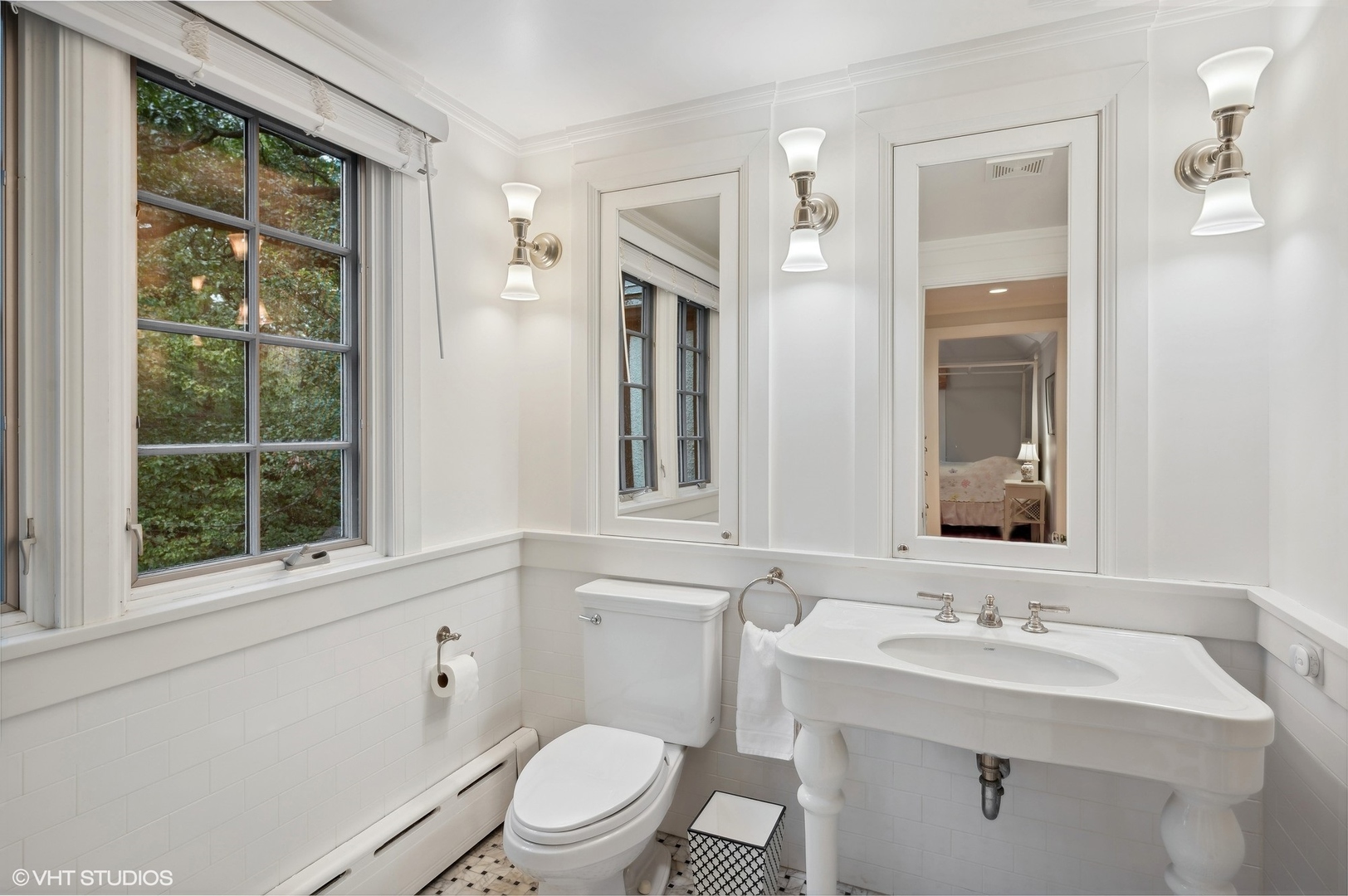 888 Tower Road Winnetka, IL 60093 - Photo 52 of 80 a bathroom with a toilet a sink a mirror a window and vanity