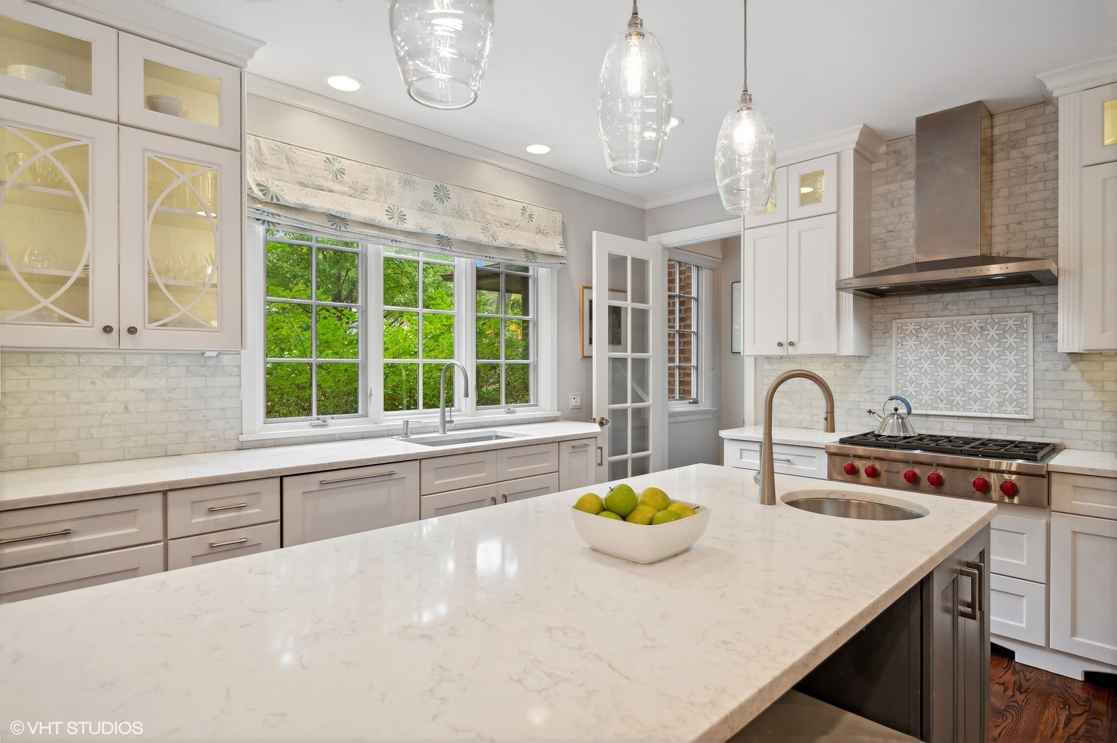 888 Tower Road Winnetka, IL 60093 - Photo 6 of 80 a kitchen with a stove a sink a counter space and a window