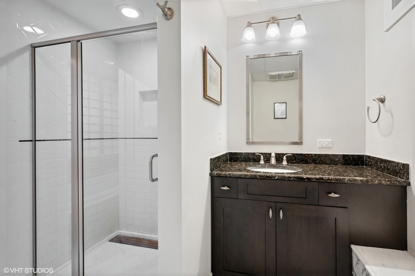 888 Tower Road Winnetka, IL 60093 - Photo 65 of 80 a bathroom with a granite countertop sink a mirror and shower