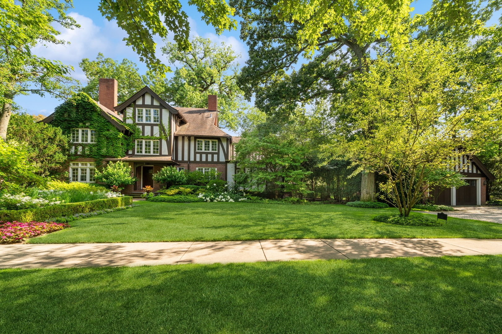 888 Tower Road Winnetka, IL 60093 - Photo 68 of 80 a view of a big house with a big yard and large trees