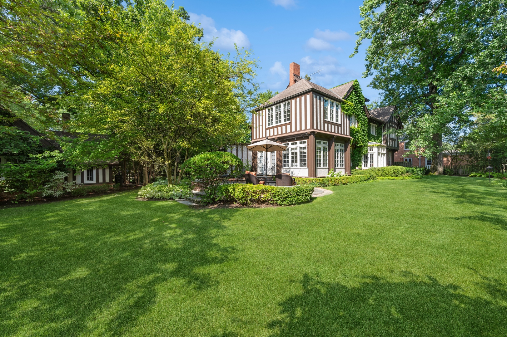 888 Tower Road Winnetka, IL 60093 - Photo 70 of 80 a view of a house with a big yard and large trees