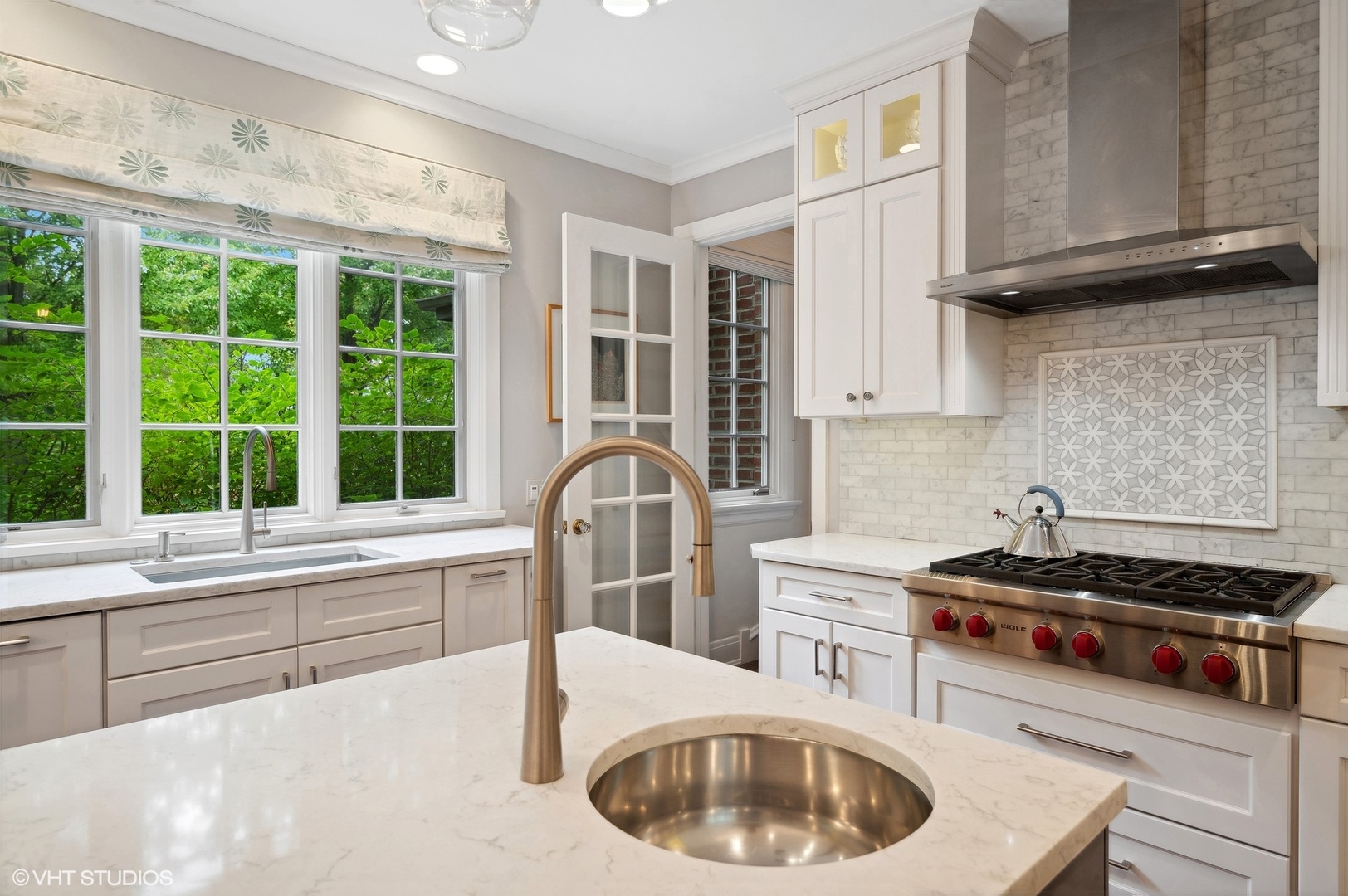 888 Tower Road Winnetka, IL 60093 - Photo 7 of 80 a kitchen with a stove a sink and a cabinets