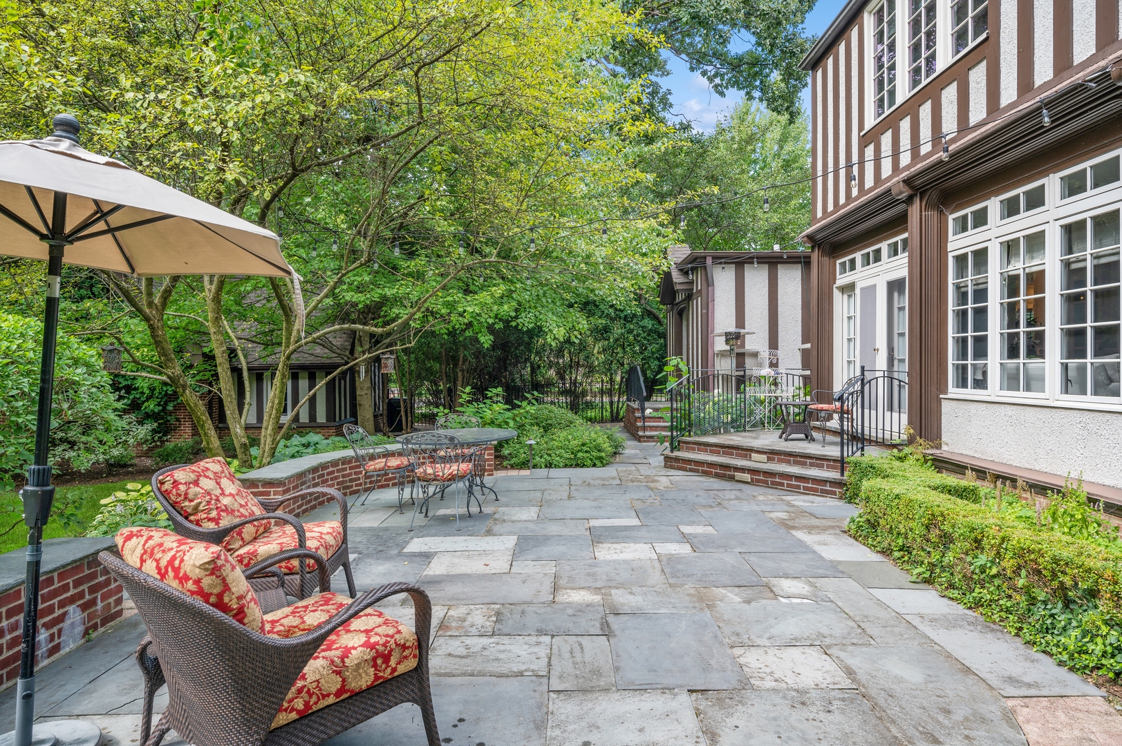 888 Tower Road Winnetka, IL 60093 - Photo 72 of 80 a view of a patio with table and chairs under an umbrella