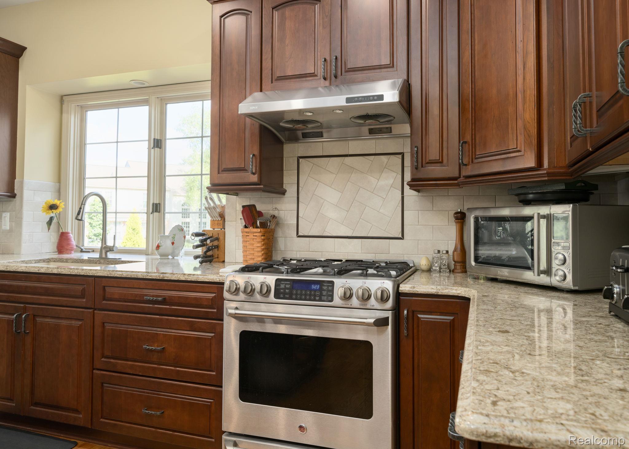 1708 Devonwood Drive Rochester, MI 48306 - Photo 9 of 70 Ceramic tile back splash, stainless appliances. Updated kitchen with soft close doors and drawers, recessed lighting and garden window over sink.