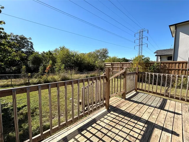 a view of balcony with wooden floor and fence