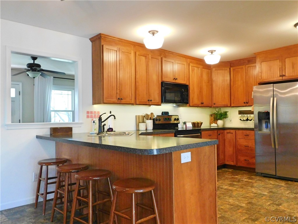 1926 Little Cub Road Pamplin, VA 23958 - Photo 3 of 32 a kitchen with stainless steel appliances granite countertop a sink a stove a refrigerator cabinets and a dining table
