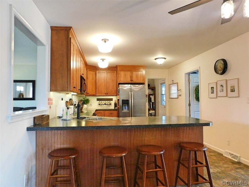1926 Little Cub Road Pamplin, VA 23958 - Photo 5 of 32 a kitchen with stainless steel appliances kitchen island granite countertop a table and chairs in it