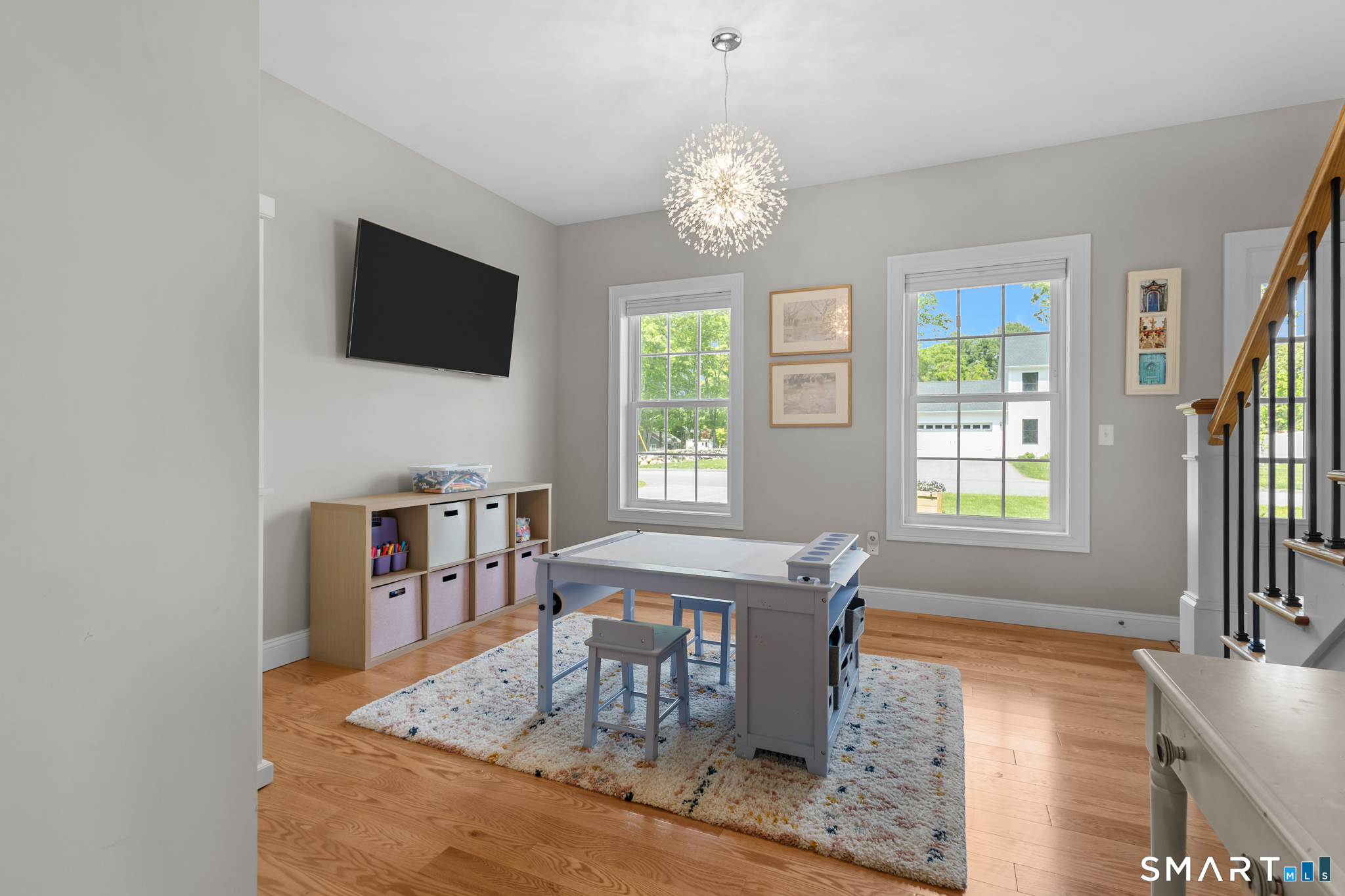 2 Martys Way Gales Ferry, CT 06335 - Photo 13 of 40 a dining room with wooden floor a chandelier a wooden table and chairs