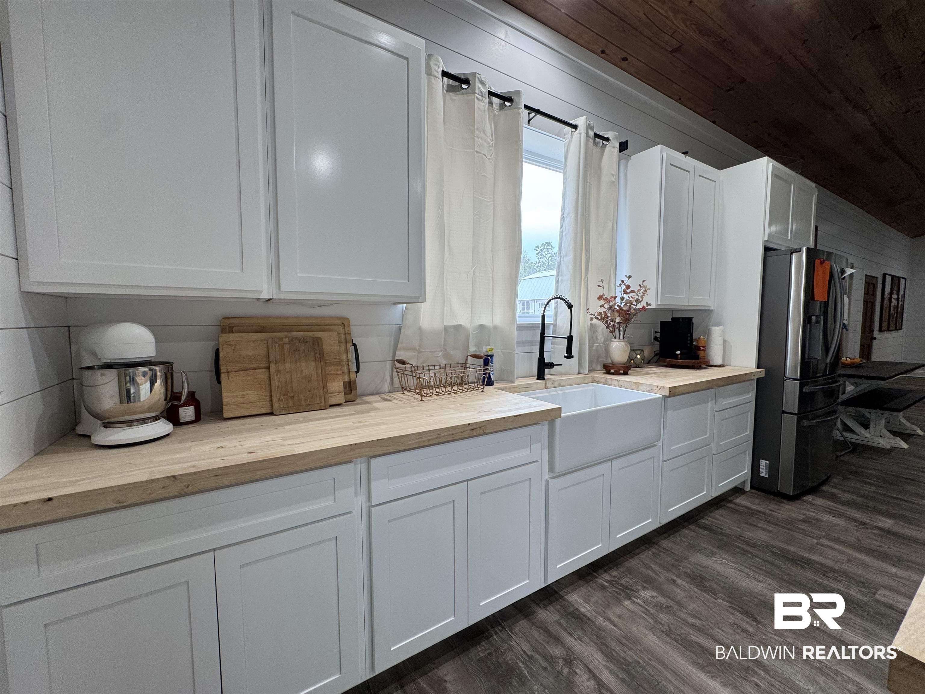 370 Dianne Road Frisco City, AL 36445 - Photo 10 of 41 Kitchen with dark hardwood / wood-style floors, butcher block counters, stainless steel refrigerator, and white cabinetry