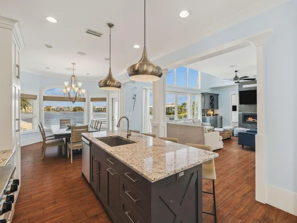 a kitchen with center island table and chairs