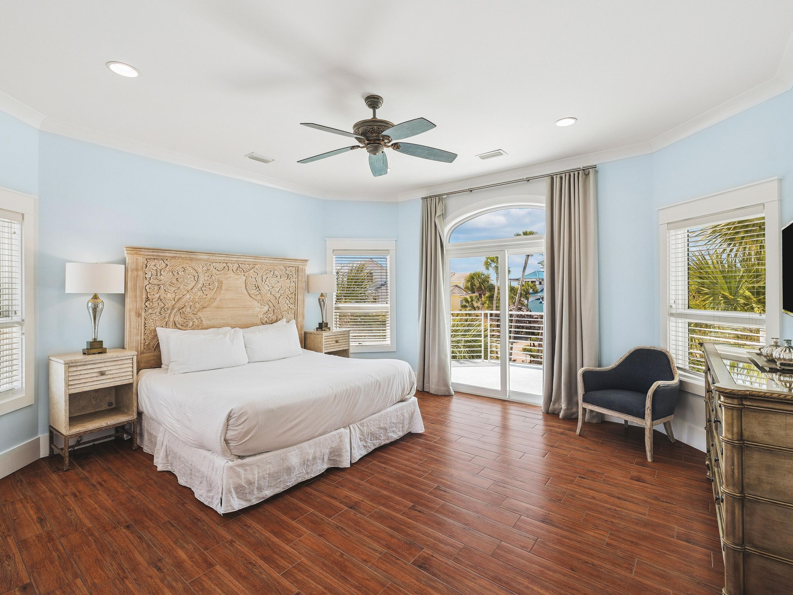 4659 Destiny Way Destin, FL 32541 - Photo 13 of 26 a bedroom with a bed and wooden floor