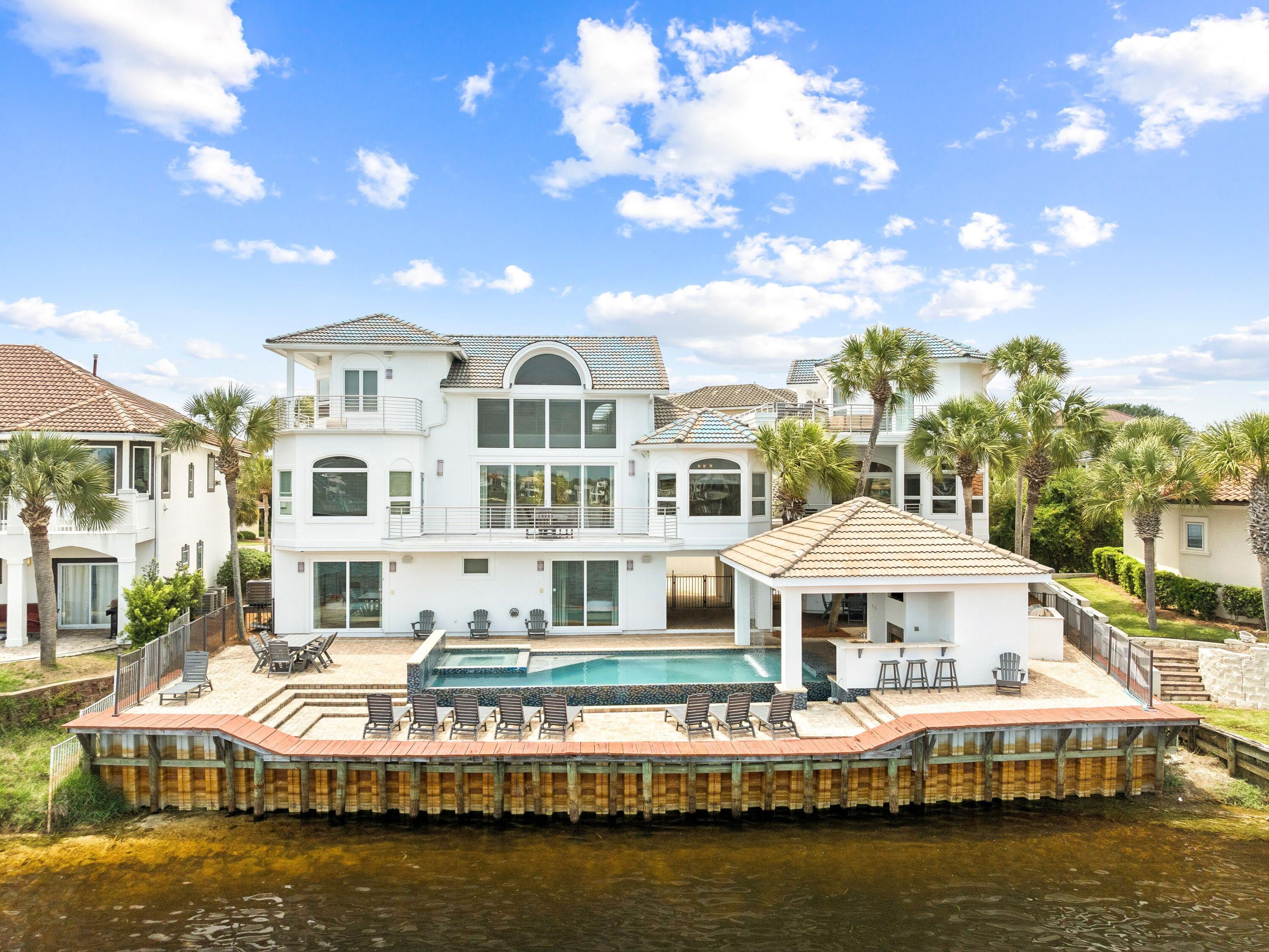 4659 Destiny Way Destin, FL 32541 - Photo 23 of 26 a front view of a building with lake view and boat
