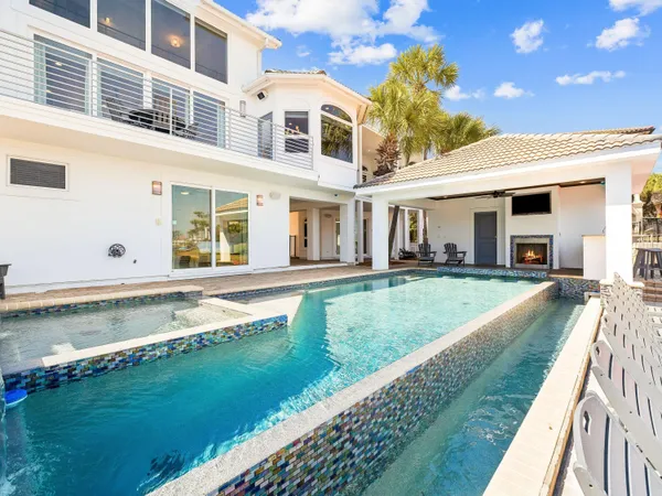 a view of a house with a swimming pool and a yard