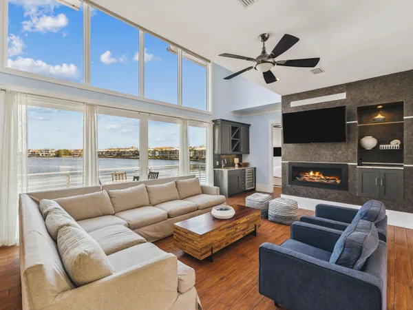 a living room with furniture a fireplace and a flat screen tv