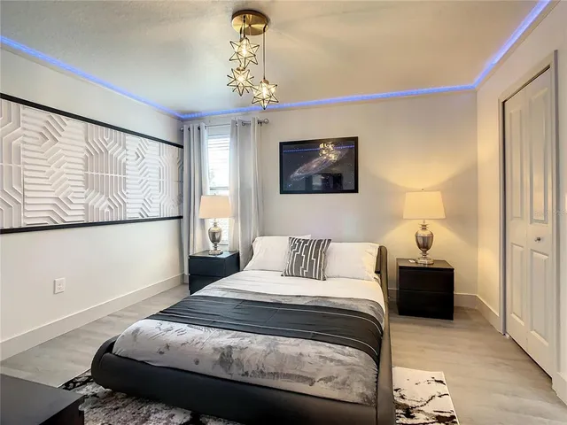 a bedroom with a bed and a chandelier