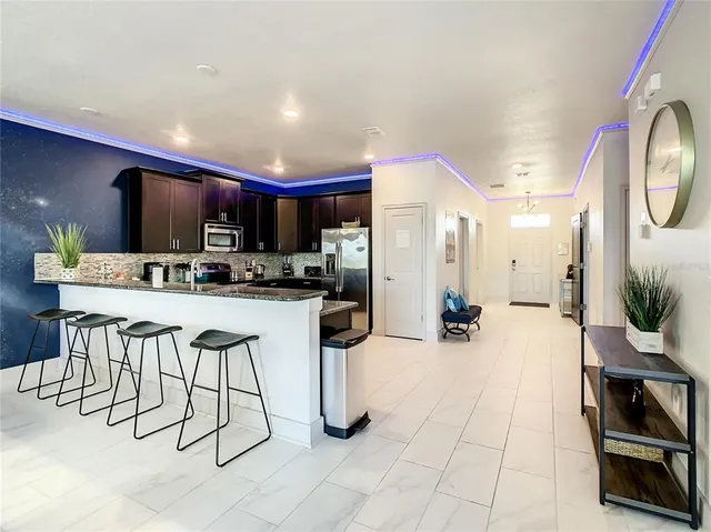 a kitchen with stainless steel appliances kitchen island granite countertop a sink and cabinets