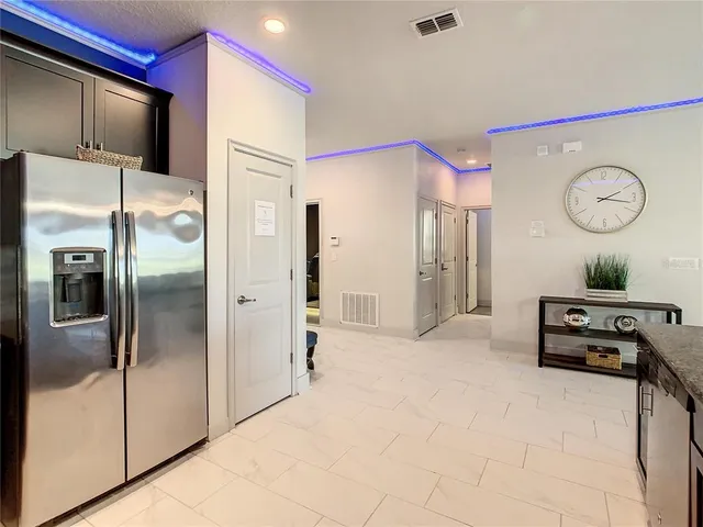 a kitchen with stainless steel appliances granite countertop a refrigerator and a stove top oven