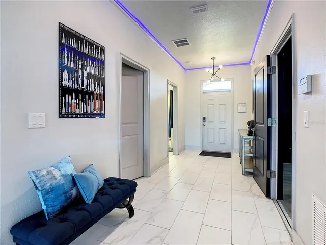 a living room with furniture and a chandelier