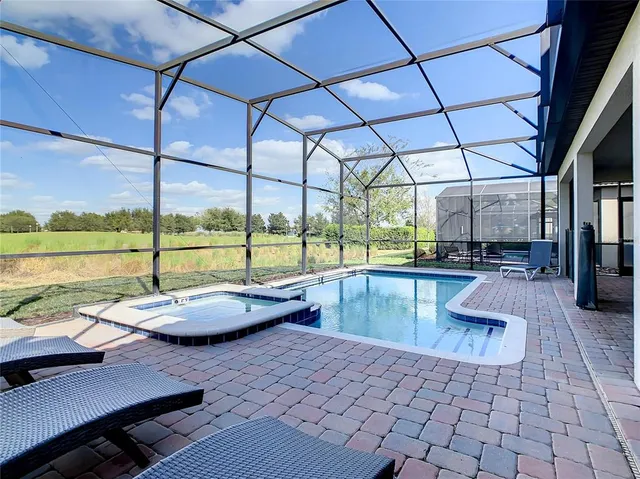 a view of swimming pool with outdoor seating