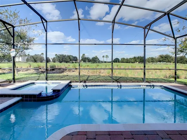 a view of a swimming pool with a lounge chair