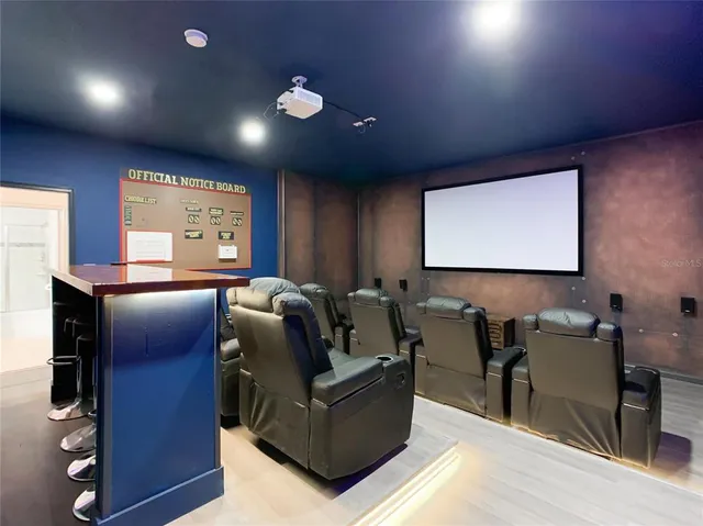 a media room with lots of chairs and a projector screen