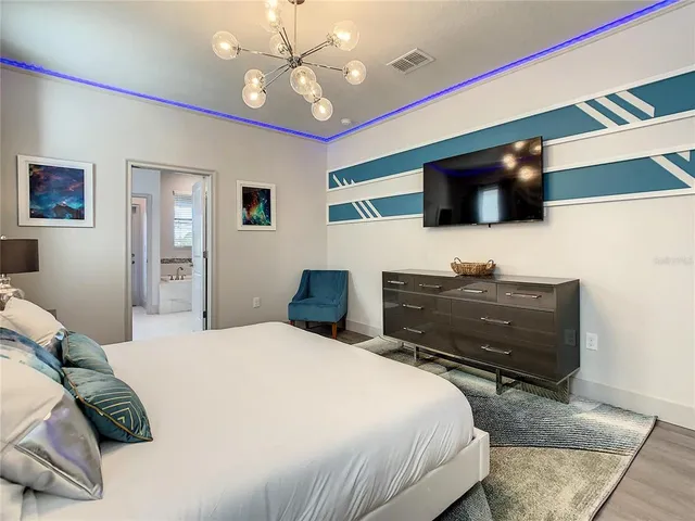 a bedroom with a bed and a television