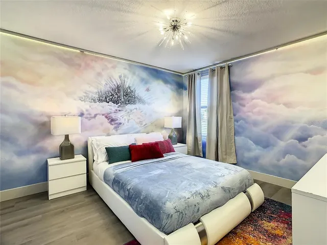 a bedroom with a bed and a chandelier