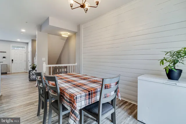 a dining room with a wooden table and chairs