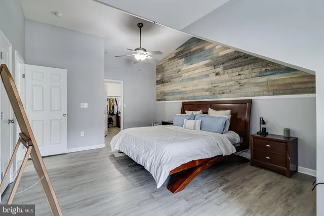 a bedroom with bed and wooden floor