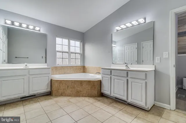 a view of walk in closet with clothes
