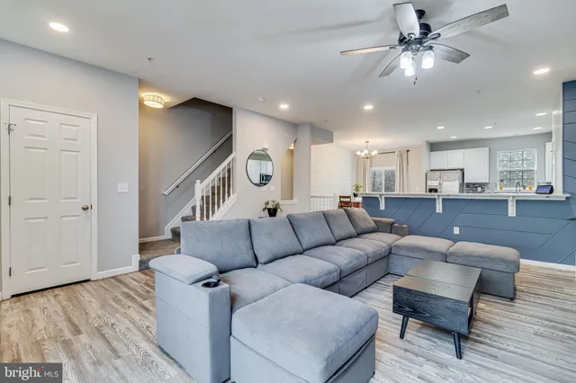 a living room with furniture and kitchen view